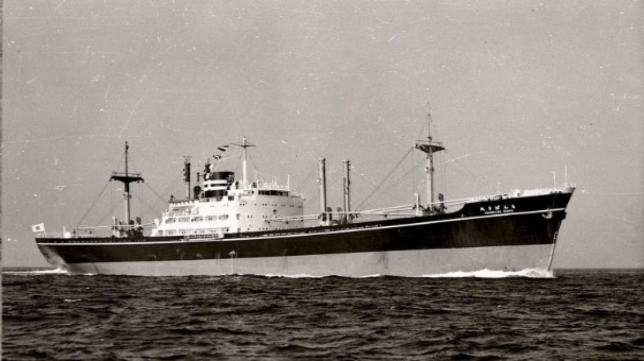 A mid-20th century Japanese cargo-passenger vessel at sea, photographed in black and white.