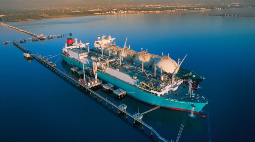 A large LNG vessel docked at a floating storage and regasification terminal, part of South Africa’s energy projects.