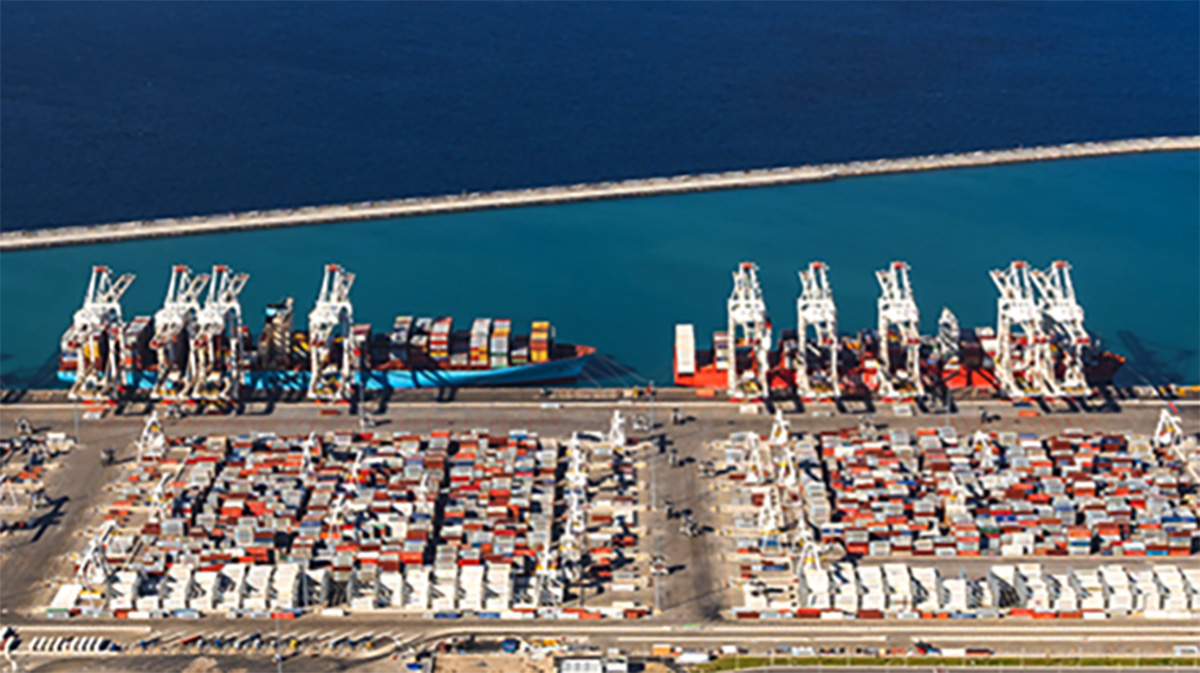 Aerial view of Morocco’s Tanger Med Port showing container terminals, cranes, and stacked cargo along the waterfront.