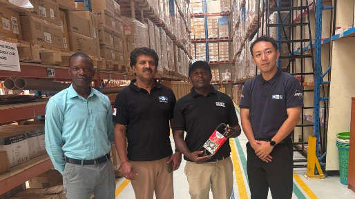 Local warehouse staff and MOL Logistics representatives standing in an automotive parts warehouse in Kenya, showcasing on-site inventory operations.