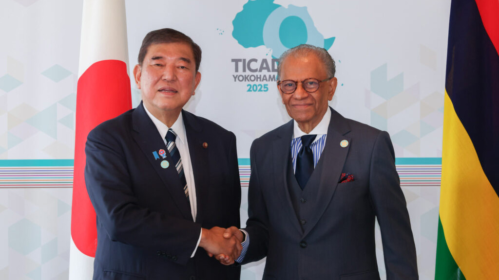 Japanese and Mauritius leaders shaking hands at TICAD 2025, highlighting bilateral cooperation and investment relations.