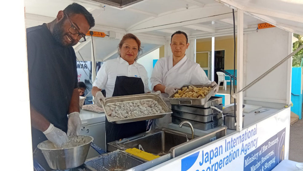 Japanese cooking class demonstrating fish preparation techniques to participants in Mauritius.